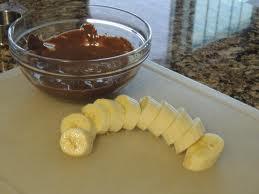 5.Dip the bananas in the chocolate and place on the wax paper.