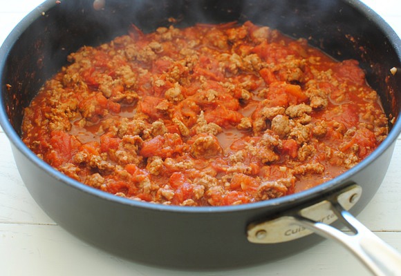  Then add the crushed tomatoes and simmer on medium until thickened, 20 minutes.
In the meantime, cook the rigatoni until it's slightly underdone. Drain and rinse with cool water. Toss with parmesan cheese. Lightly oil a 9-inch spring form pan.