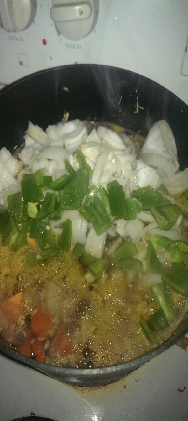 after about 10 minutes I add the green pepper and yellow onion. let that simmer for about 10 minutes stirring occasionally. add corn and rottel 