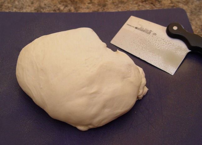 8. Spray your counter, or a cutting board with cooking spray. Lay your dough on top of it.