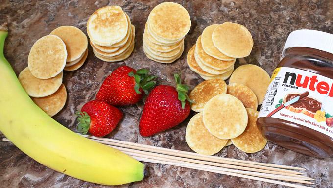Okay, gather up the goods. You'll want the pancakes, bananas, strawberries, Nutella, and kabob skewers.
