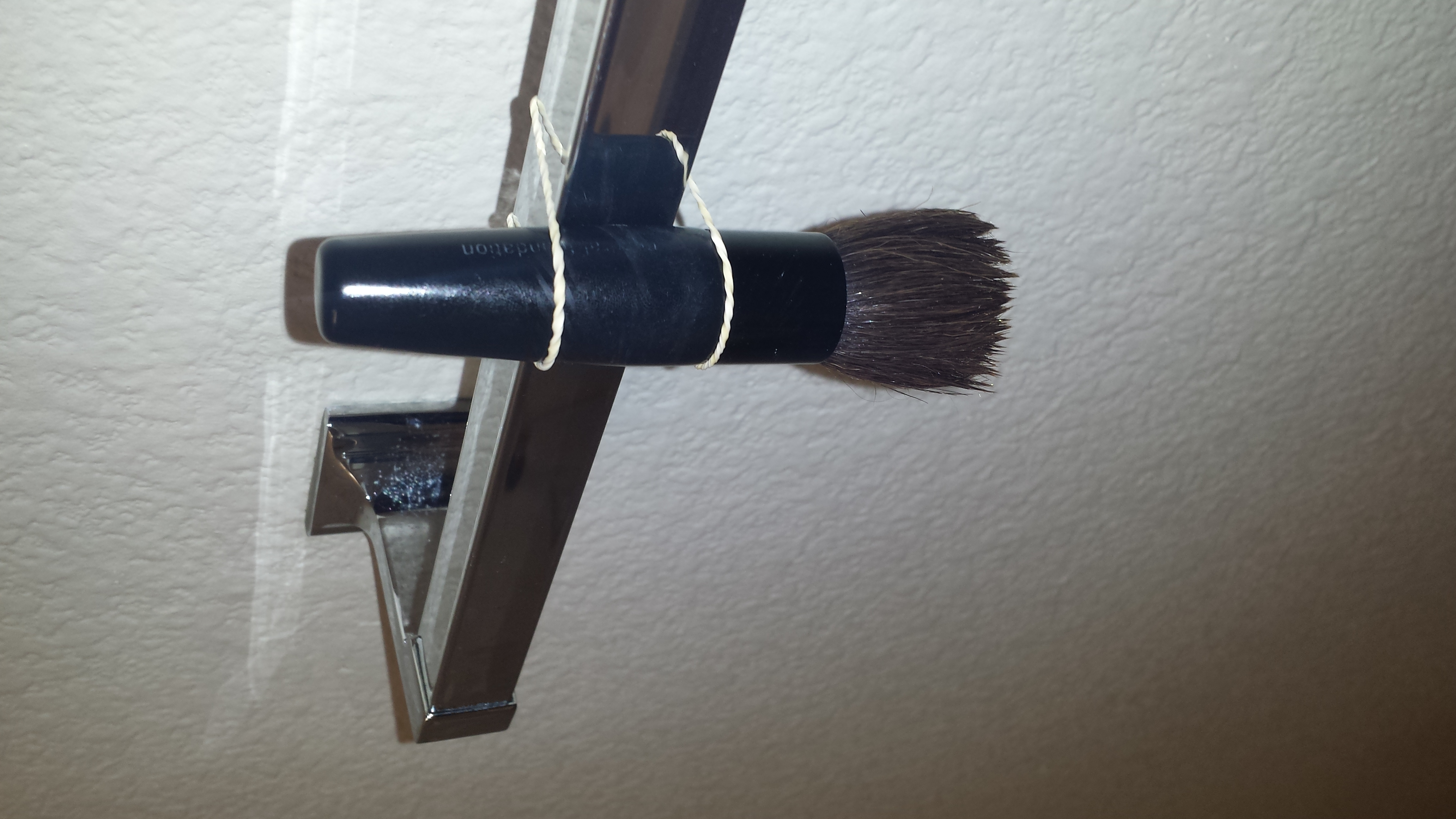 and then hang it on the towel holder with your hair tie facing down p.s. i recomment doing this at night so that in the morning all your brushes are dry