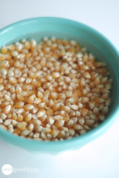 Soak your popcorn kernels in water for a few minutes before popping. The water helps them pop faster and you end up with fewer unpopped kernels! 