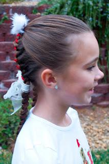Start with one side of your ribbon and weave it back and forth through both sets of braids - making sure to alternate your left and right sides.   When you get down to the bottom of the "French" part of your braid, secure that ribbon by tying it around the braid and then knotting it.  Cut off extra.