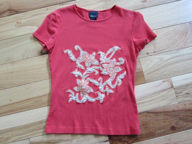 Cut Sleeves Off of Shirt
Lay your t-shirt out on a flat work surface. Using a sharp pair of scissors cut the sleeves off of your t-shirt.