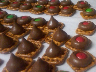 Picture says it all. On a sheet of wax paper place small pretzels topped with a kiss💋 place in oven at 350 for 3-5 mins or until Hershey kiss is slightly melted. Immediately from the oven place a m&m on top of the kiss. Let cool. Try with Reese's pieces as well