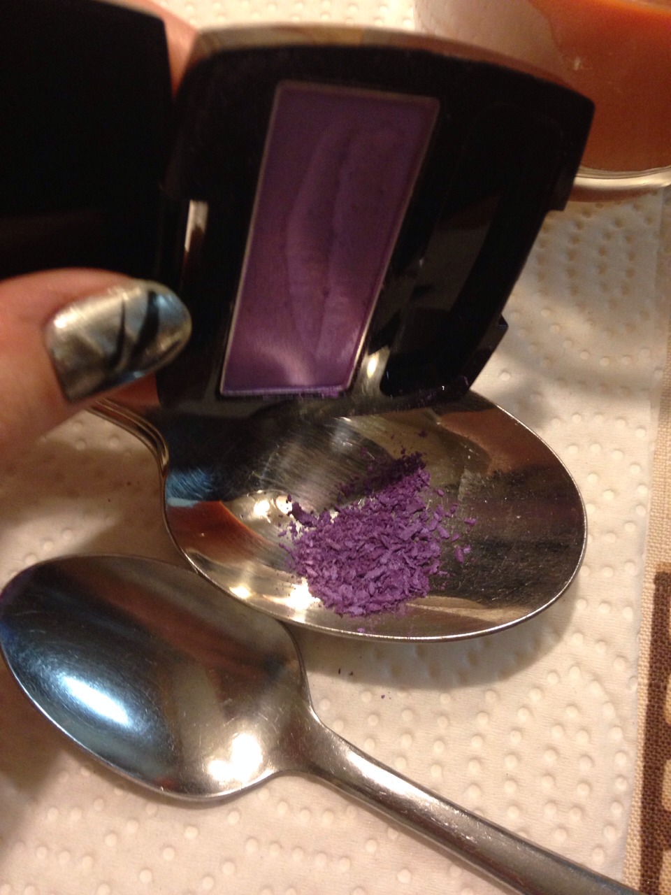 Crush up your powdered eyeshadow into a spoon (or a dish). (Be sure to keep the container, you will need it later) 