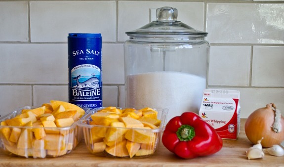 2 20-ounce packages pre-cut butternut squash (if using fresh squash, you'll need one large squash)
1 red bell pepper, roughly chopped
1 medium yellow onion, roughly chopped
3 cloves garlic, smashed and peeled
7 cups water
1 tablespoon salt
2 tablespoons sugar
1/2 cup heavy cream
Fresh thyme sprigs