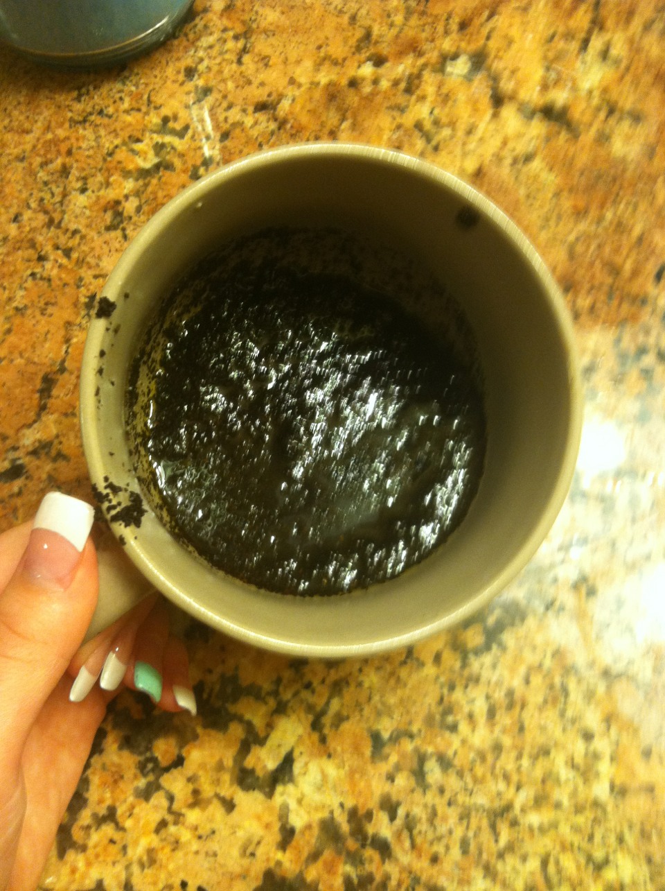 Get a cup and put used or new coffee grounds. Mix it with olive oil, or corn oil. I used olive oil