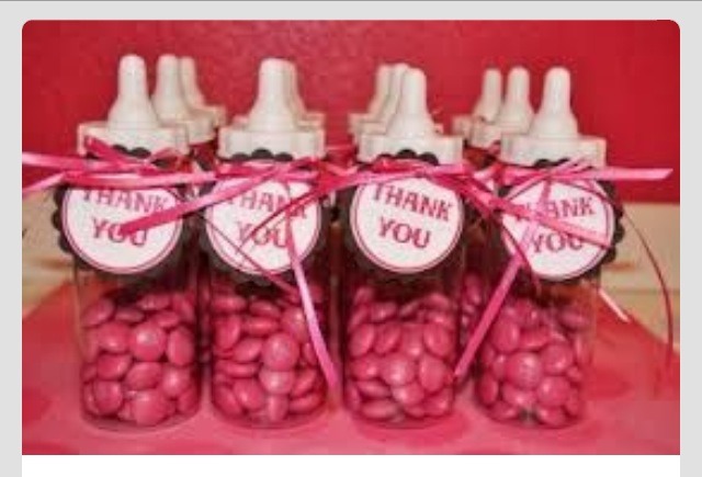 Pink M&Ms or skittles in a baby bottle 