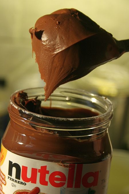 Next, GO CRAZY! Add as much Nutella as you like all over the top. I usually use 3/4 of a jar.. 😳 It's usually better if you melt it in a separate bowl in the microwave for about 30 seconds and pour over, however this is optional.