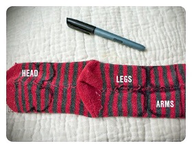 1. Flip your sock inside out and draw the head and ears at the toe end. The heel becomes his little bum and you draw out the legs on the other side of that. The rest of the sock cuff becomes his arms.