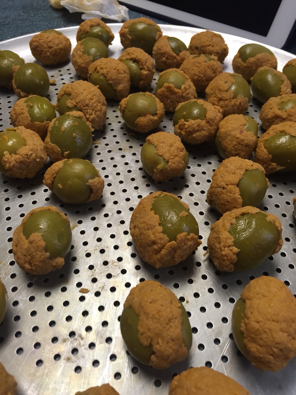 Lay out the olives on a tray until they are all stuffed and ready to roll. 