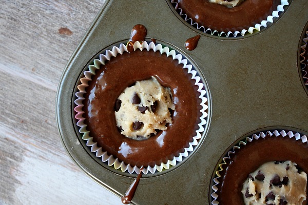 Add in a little cupcake batter into the trays and then put small balls of cookie dough (premade is the best because the dough doesn't cook all the way) in and then top the dough with more cupcake mix.