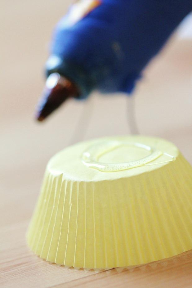 Separate your cupcake liners - it makes it easier to grab them. Put a circle of hot glue on the bottom of each one, and stick them on. It's that easy