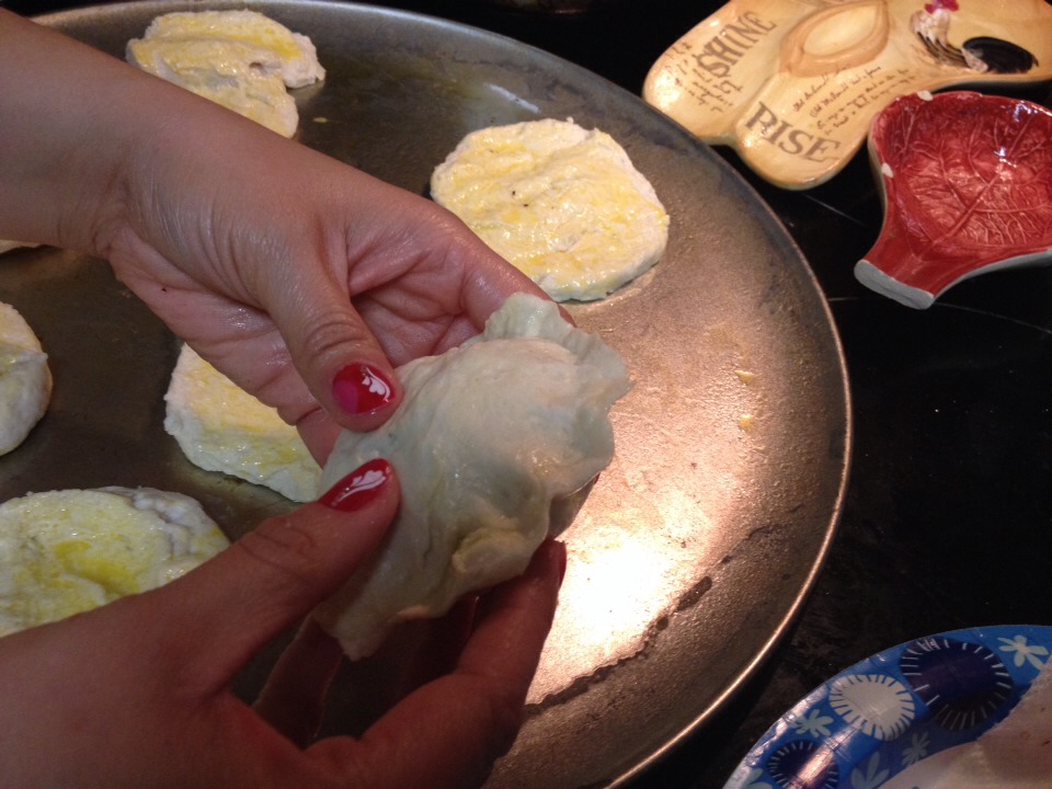 Pull top of biscuit over and pinch the edges to seal the biscuit. 