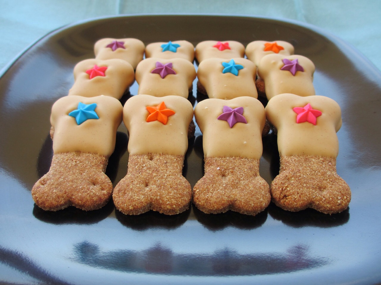 Preheat oven to 400 degrees F Grease cookie sheets. Mix together flour, all-purpose flour, cornmeal and oats. Make a well in the center of the dry ingredients and gradually pour in water, oil, eggs, peanut butter and vanilla. Mix well. 