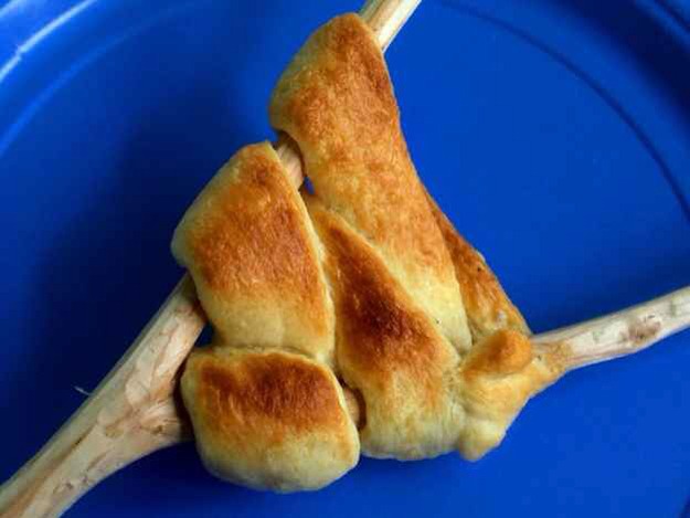 Pillsbury crescent rolls over an open fire .
