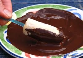 While the bananas are in the freezer boil a pan of water and place a heatproof bowl over to melt the chocolate of your choice. Once done cover your frozen bananas in chocolate and add your sprinkles, I use nuts! 