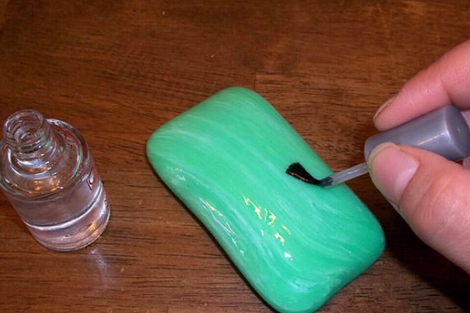 Paint a bar of soap with clear nail polish and put it in the shower