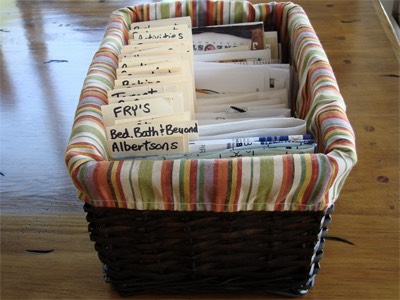 Use some old file folders and cut them up into strips. Dedicate each piece of file folder to one category, and staple it to the inside back corner of an envelope. Corresponding coupons go in the envelope. Done.