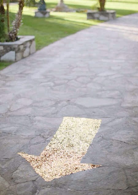 -> A gold sequined arrow that shows guests where to go