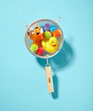 Colander as Toy Scoop
One of the most popular kitchen tools also happens to double as a clean-up aid. Before draining the tub, use a colander to make scooping up small toys fun and easy.