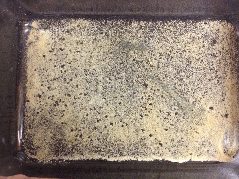 On the bottom of your pan, before you add any shrimp or butter, sprinkle garlic, onion, and some fresh cracked black pepper so it looks kind if like this. You want more garlic than onion.