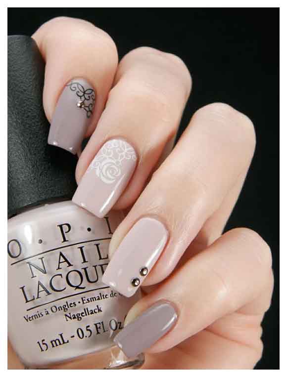Cute nude nails with small designs are in