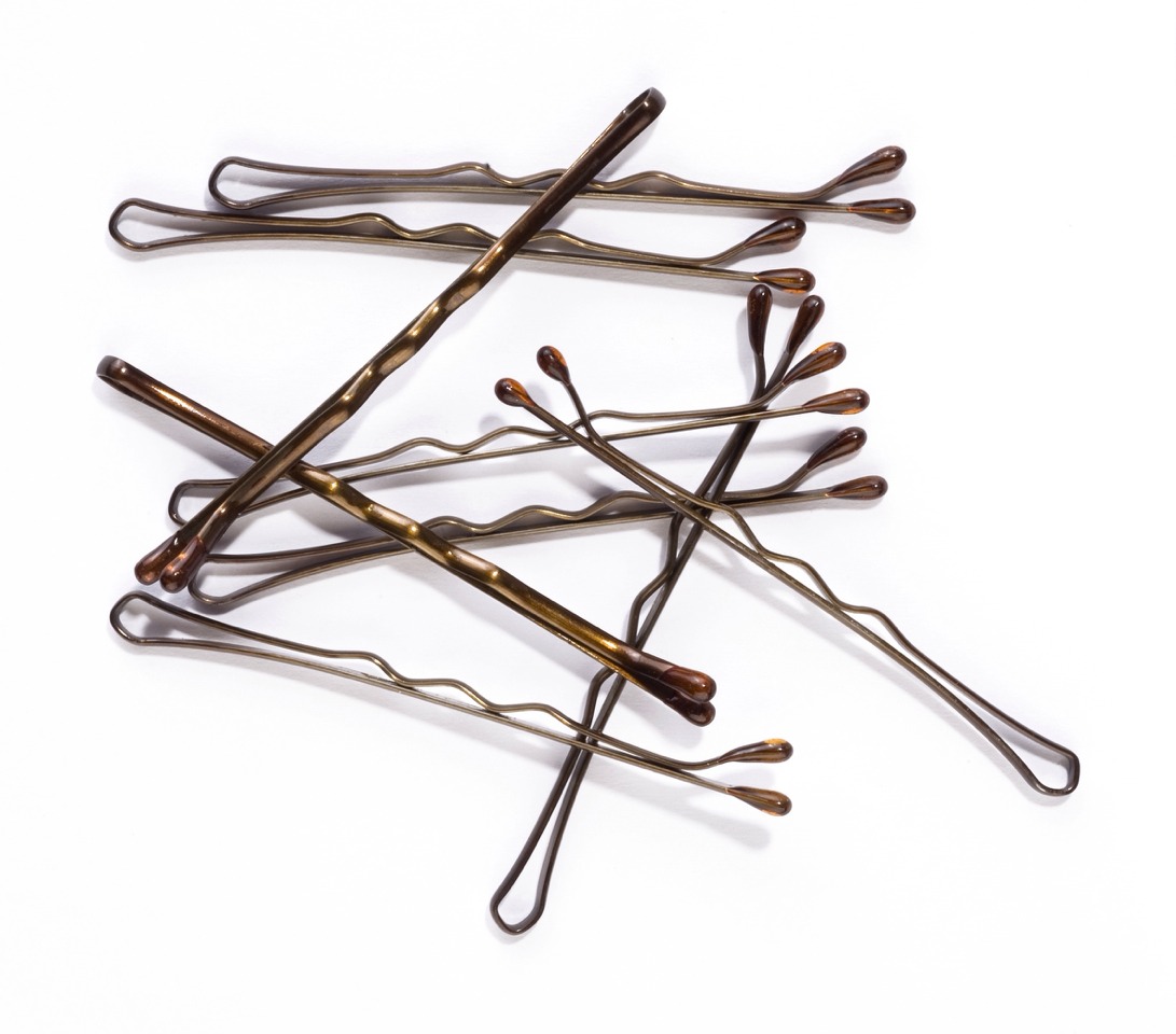 Bobby Pins!

Carry these and hair ties so you don't have to worry about bangs in your eyes or hair flying everywhere when the wind picks up!