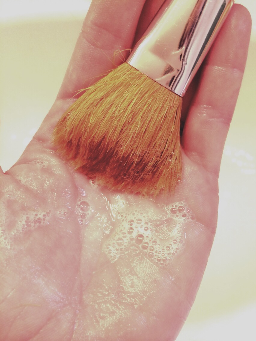 If you see that the water isn't running clear, add a little more shampoo to the palm of your hand and gently swirl the brush on top of it, forming a little bit of a lather. Don't be too harsh with it, swirl and sweep on your soapy hand as you would do if putting makeup on your face. 