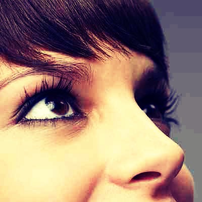 Before applying mascara, place a business card or index card behind your lashes to cover your lid. Starting at the roots, swipe mascara all the way to the tip. You can really let the wand fly so it lengthens without making a mess—the mascara will just hit the card!