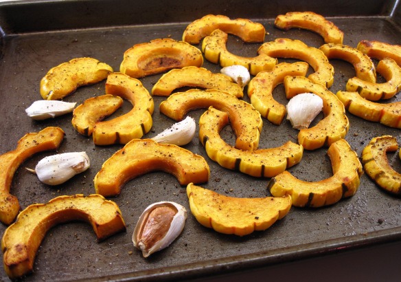 5. Roast for about 30 minutes, until tender. Squeeze the garlic cloves out of their skins and serve with the squash.