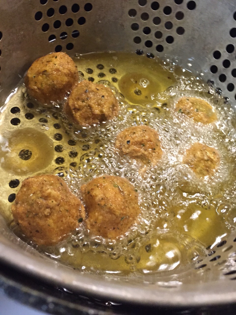 Cooking olives after freezing. 

Use a deep fryer. 

Place a few in a basket at a time. 