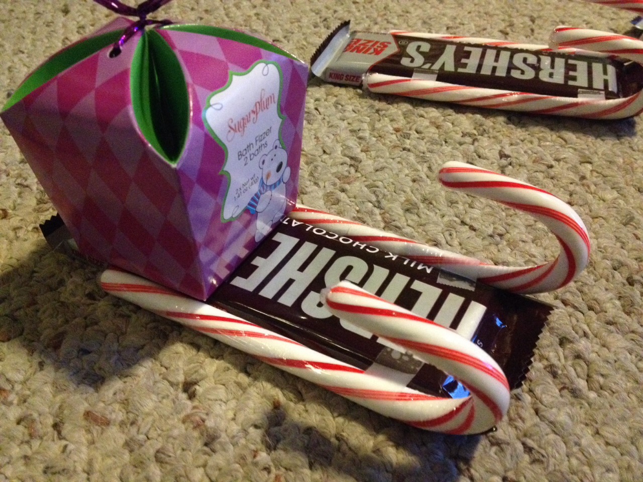 Tape on the present.
Or you could tie on a cute little stuffed animal (: