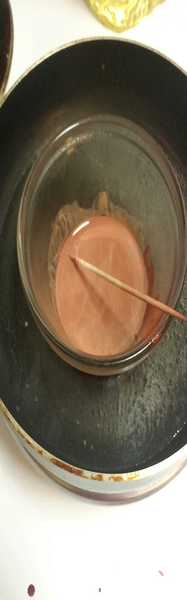 put a small glass container in a pan with a few inches of water to boil and melt the crayons. I used about one Tsp. of vegi oil, the more oil the more glossy your lip balm will turn out. 