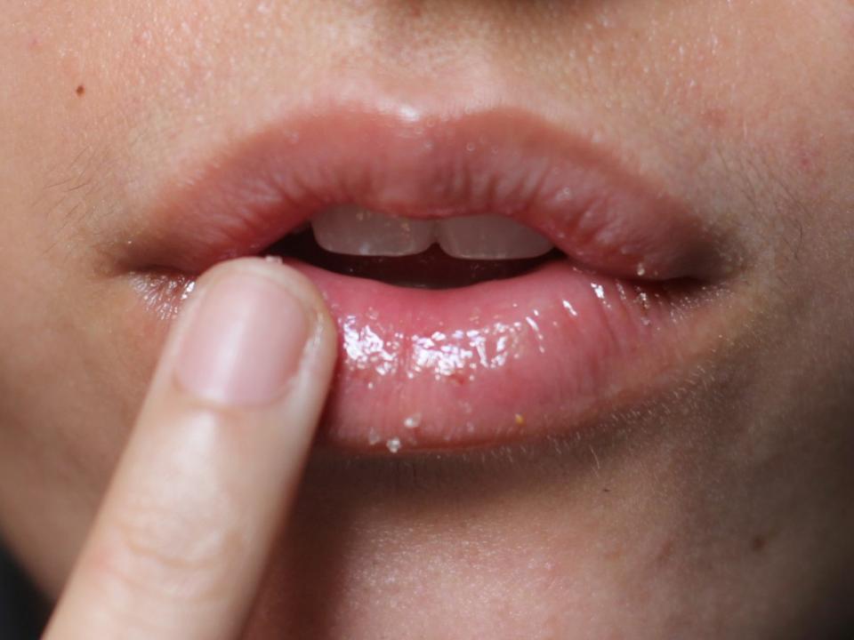 Exfoliate your lips by massaging a sugar or salt scrub in small, circular motions. We recommend using a lip scrub infused with vitamins so you can nourish your lips as it heals.