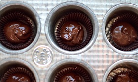 First, plop some chocolate in your mini paper cupcake liners.
