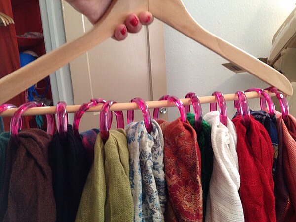 Use shower hooks on a hanger to hang all of your scarves up 