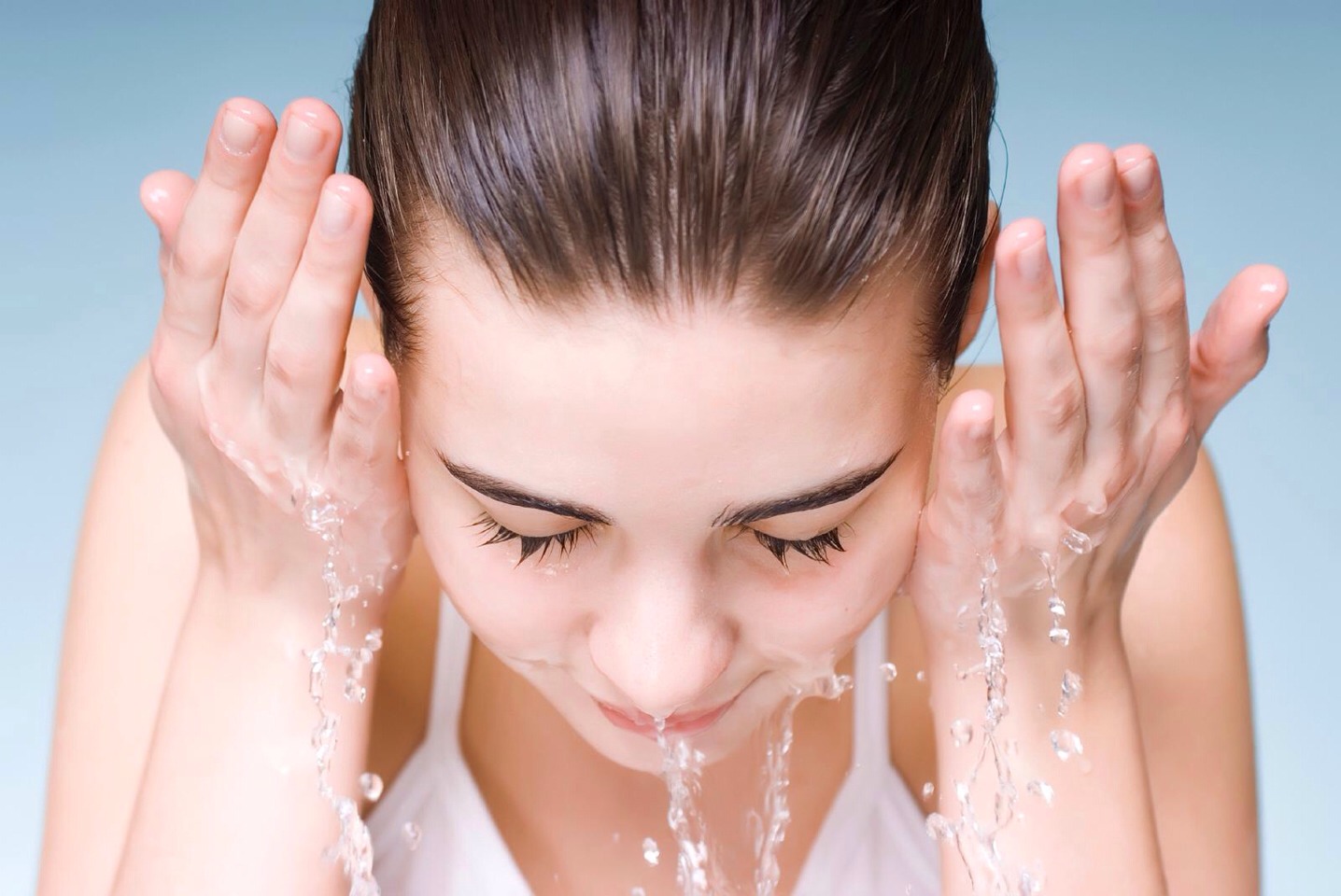 Wash your face twice a day. Morning and night with a gentle exfoliating wash to wash away excess oils that would create spots. 