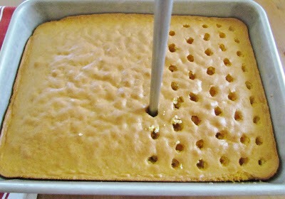Directions:
Prepare cake mix according to package directions for a 9x13 cake.
Once cake comes out of the oven, allow it to cool for just a couple of minutes.
Then, with a wooden spoon handle or some other similarly-sized object, begin poking 
holes in the cake