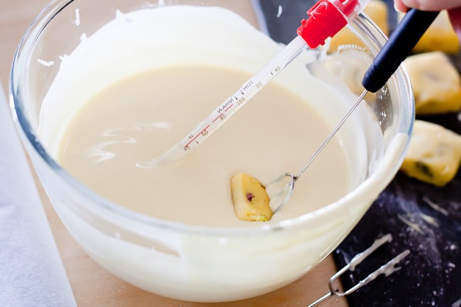 5.Temper the white chocolate.

6.Carefully lower each square of marzipan into the chocolate with a dipping fork.
