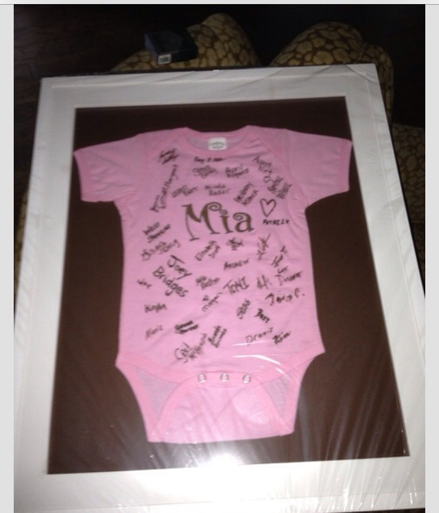 Frame a onesie that everyone from the baby shower has signed. 
