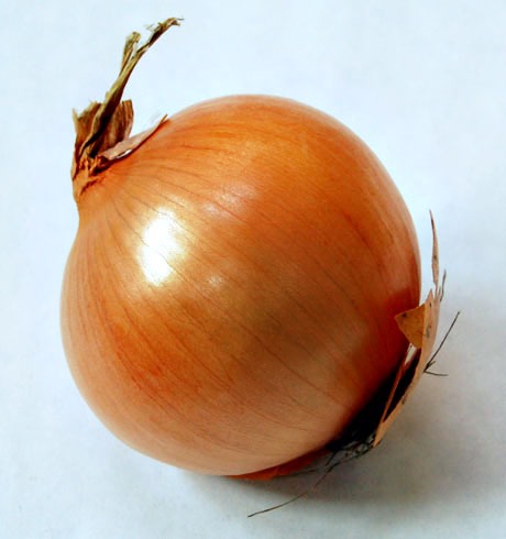 Chop onion (and garlic if necessary). In a medium non-stick frying pan heat 1/4 of oil and sauté just the onions until translucent. Add garlic and cook for about 2 minutes making sure it does not burn. Then add entire package of frozen spinach, lower heat to low. 
