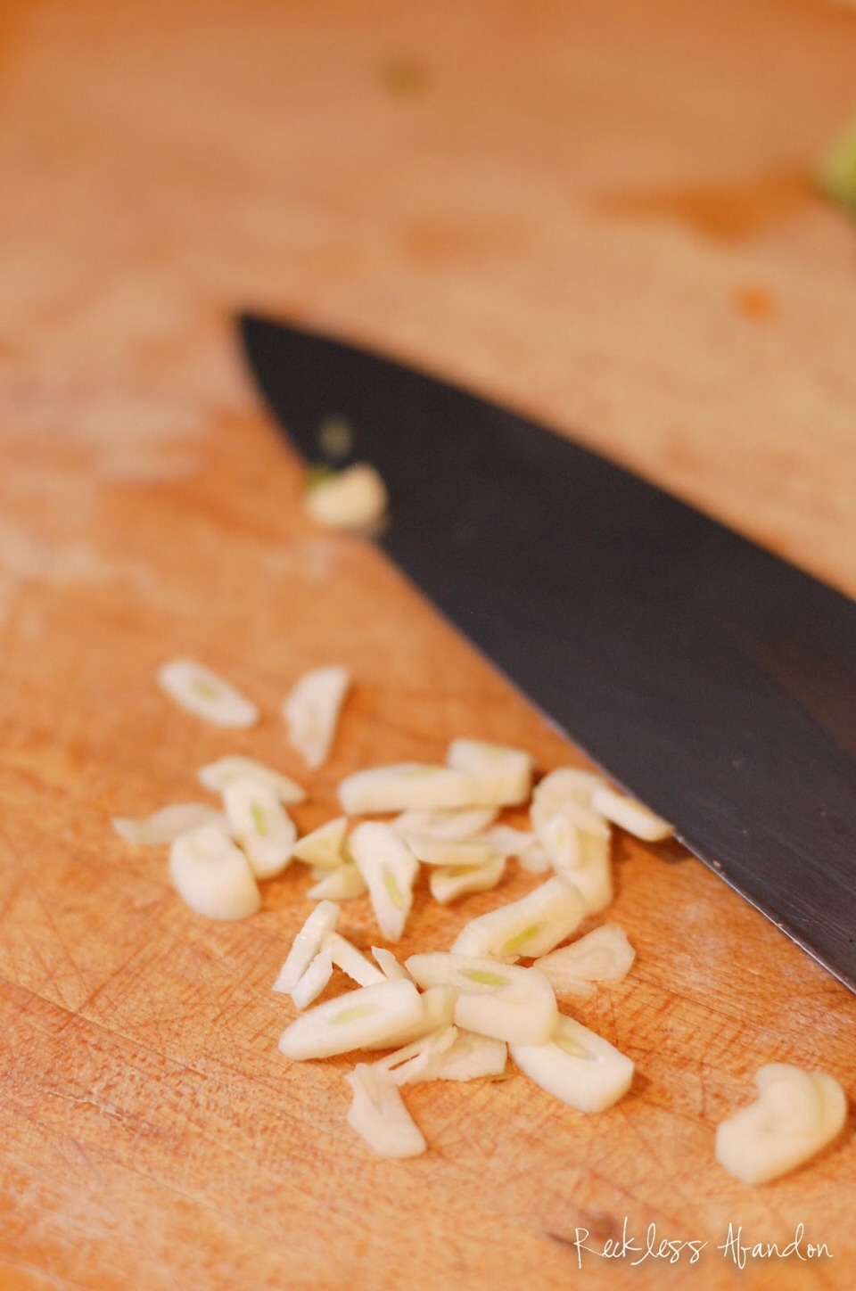 Finely chop a clove of garlic, and cut the pepper into small chunks. Add these to the mixture. 