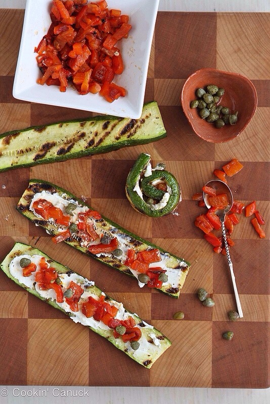 -> Remove the zucchini from the grill and set on a wire cooling rack.
-> Spread about 1 teaspoon of goat cheese on each zucchini slice. 
-> Divide the red pepper and capers evenly amongst the zucchini.
-> Gently roll each piece of zucchini. Serve. 