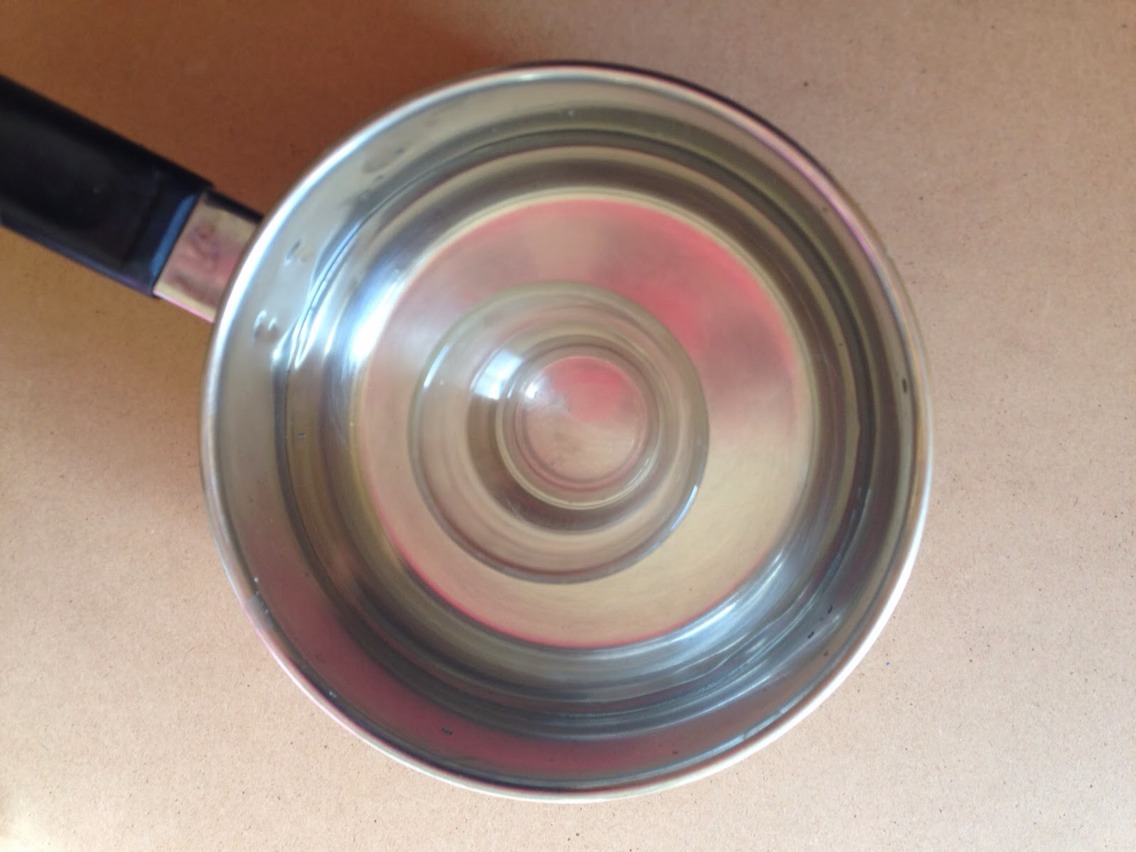 Put your jar in the centre of the pot and then fill the pot with water, be careful not to get any water into the jar though. Put a teaspoon of the coconut oil into the jar and heat on a low-medium heat...