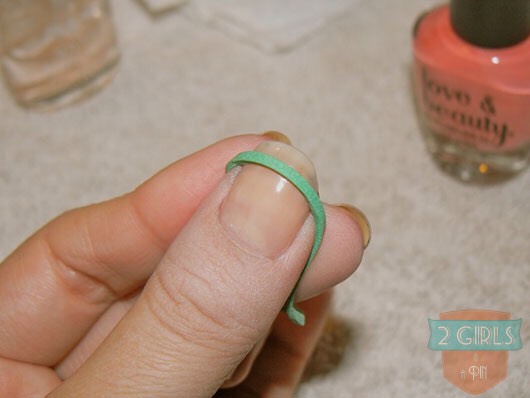 Place an elastic on the tip of your nail to get the perfect french manicure