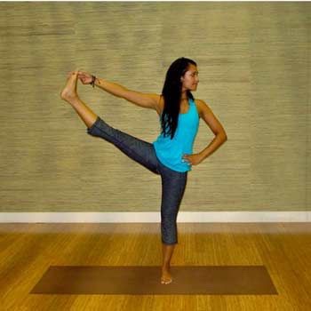 7. Utthita Hasta Padangusthasana/Extended Hand-To-Big-Toe Pose
As the name suggests, Utthita Hasta Padangusthasana involves extending your hand to your big toe. This is a pose for those who have been practicing yoga for a while because it needs extreme flexibility and a strong sense of balance.