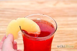 Garnish the glass with a slice of pineapple